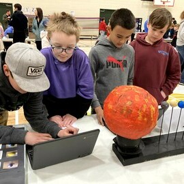 Student with solar system project