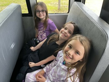Kids on a bus travelling to a field trip
